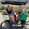 Taking a pedicab to Sip Into Spring Festival in Palisade, CO with Palisade Pedicab