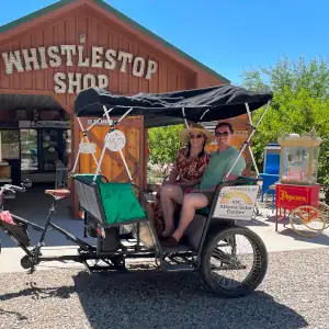 A couple enjoying a wine tasting tour in Palisade, CO with Palisade pedicab