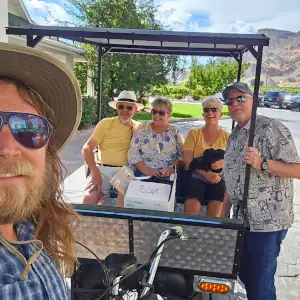 A family getting a ride to a winery in Palisade, CO with Palisade Pedicab